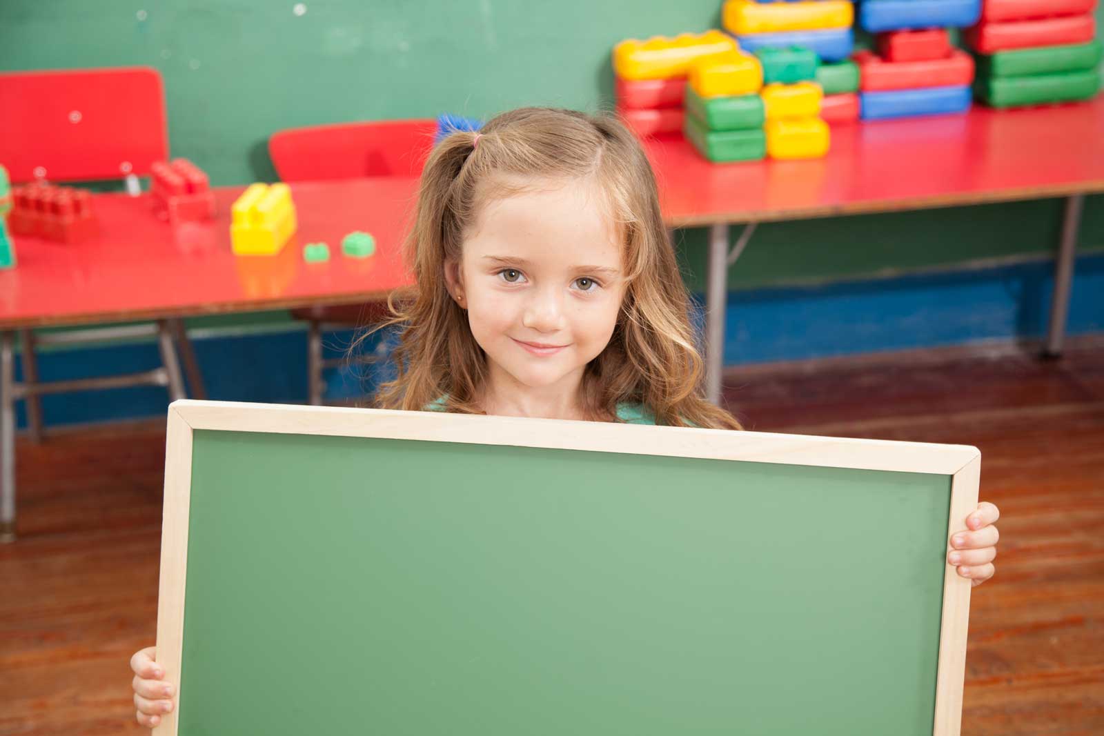 Young Girl Holding Chalk Board